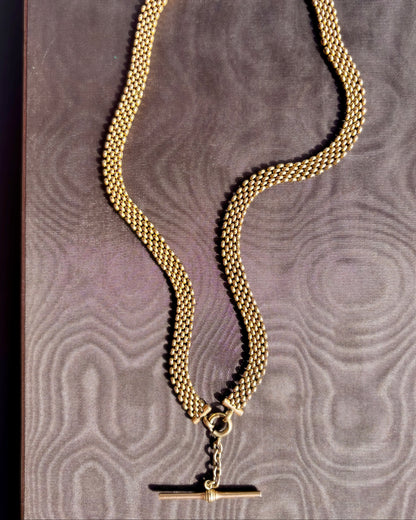 An antique gold-fill chain necklace with a toggle clasp