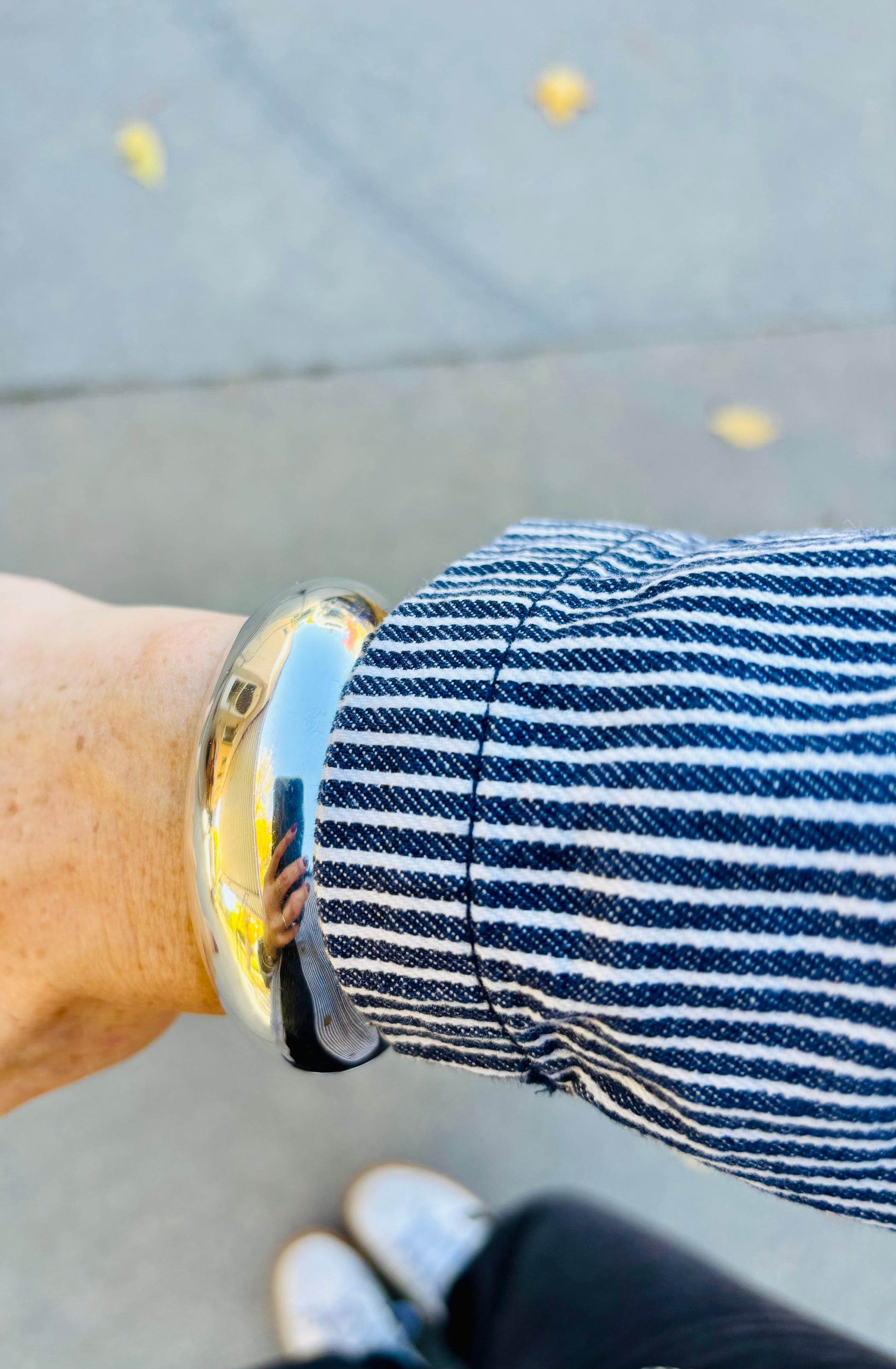 Sterling silver cuff bracelet styled with jacket