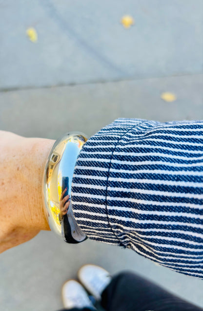 Sterling silver cuff bracelet styled with jacket
